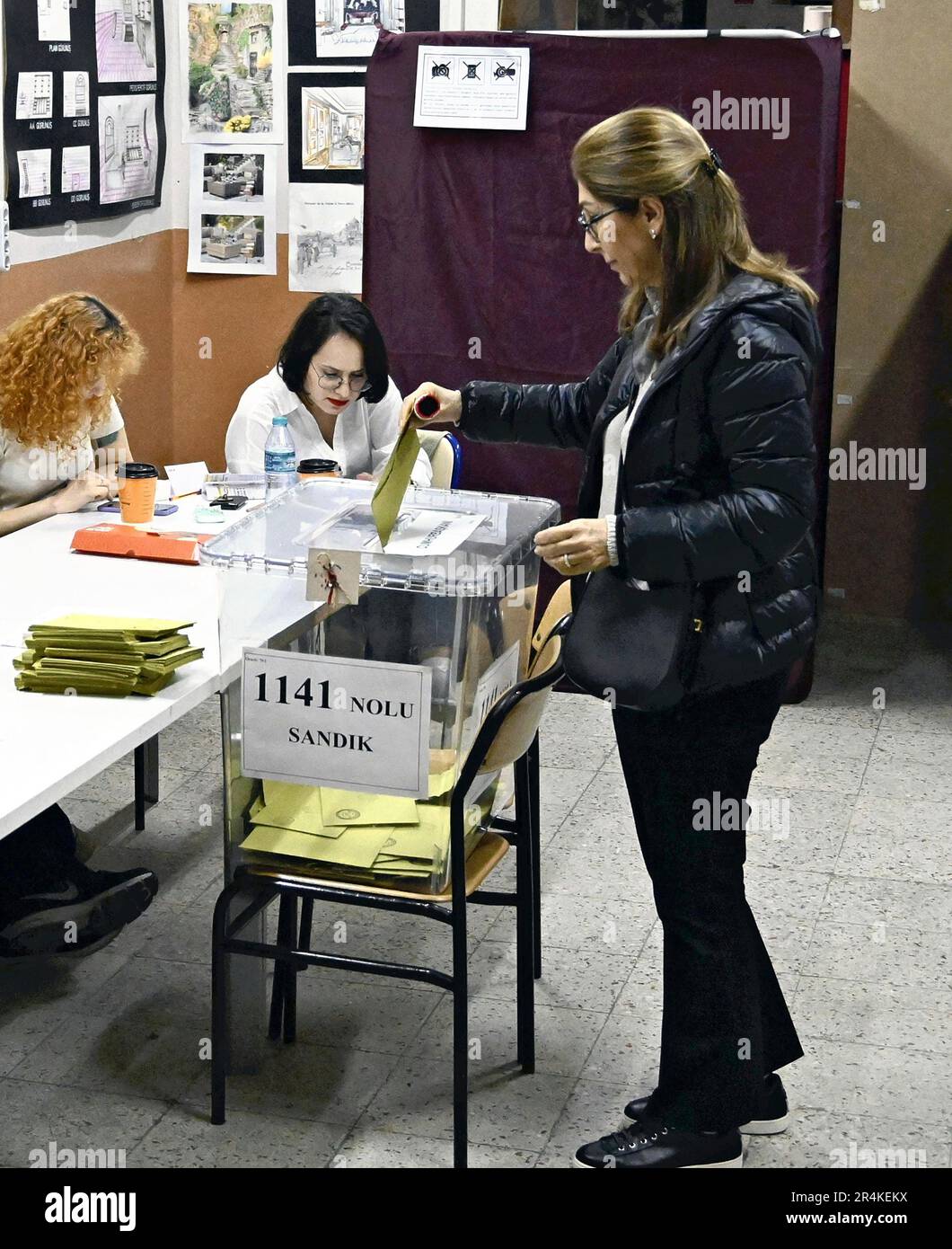 A qualified voter casts her ballot for the presidential runoff election