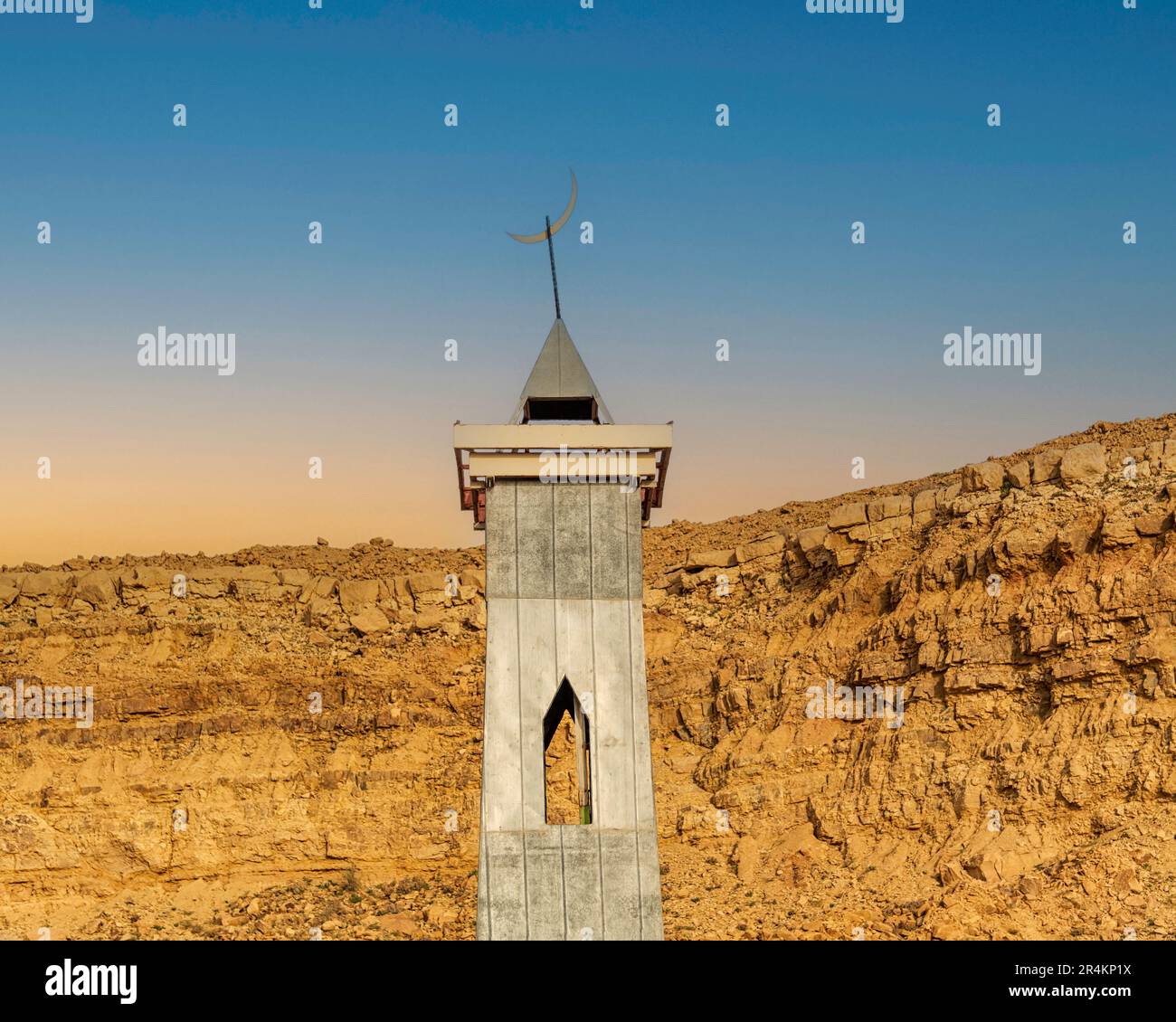 Mosque Minaret against Cliff - Dusk view Stock Photo