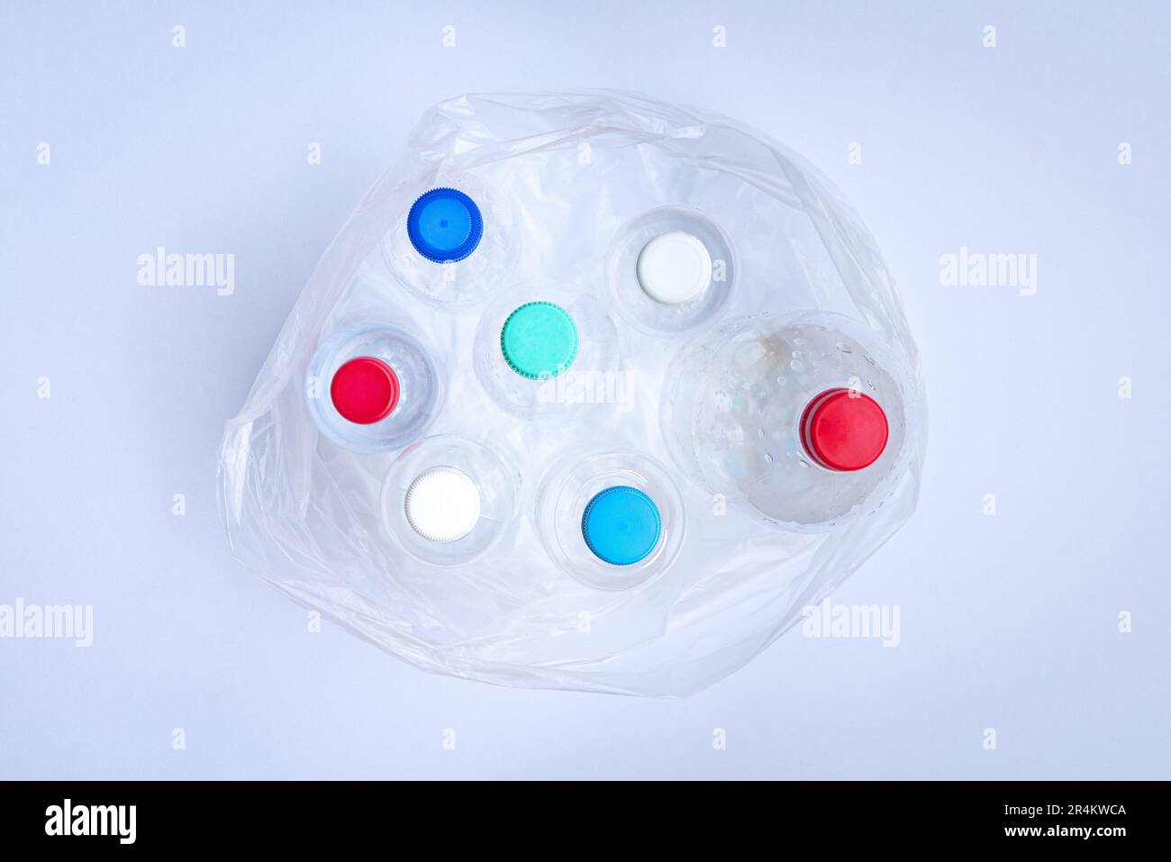 Plastic bottles inside a plastic bag. Top view, on white background. Stock Photo