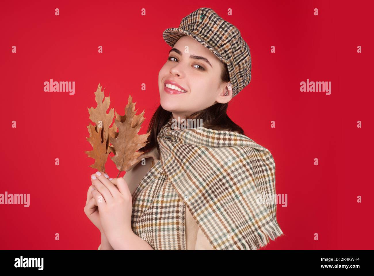 Studio isolated portrait of young happy woman with autumn fall leaves ...
