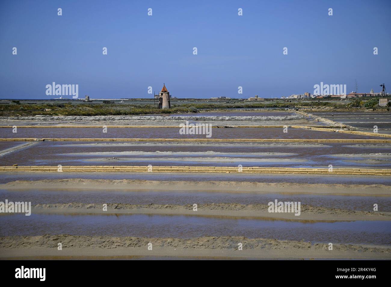Landscape with panoramic view of Salina Chiusicella a traditional salt pan in the Natural Reserve of Trapani and Pacheco, Nubia Sicily Italy. Stock Photo