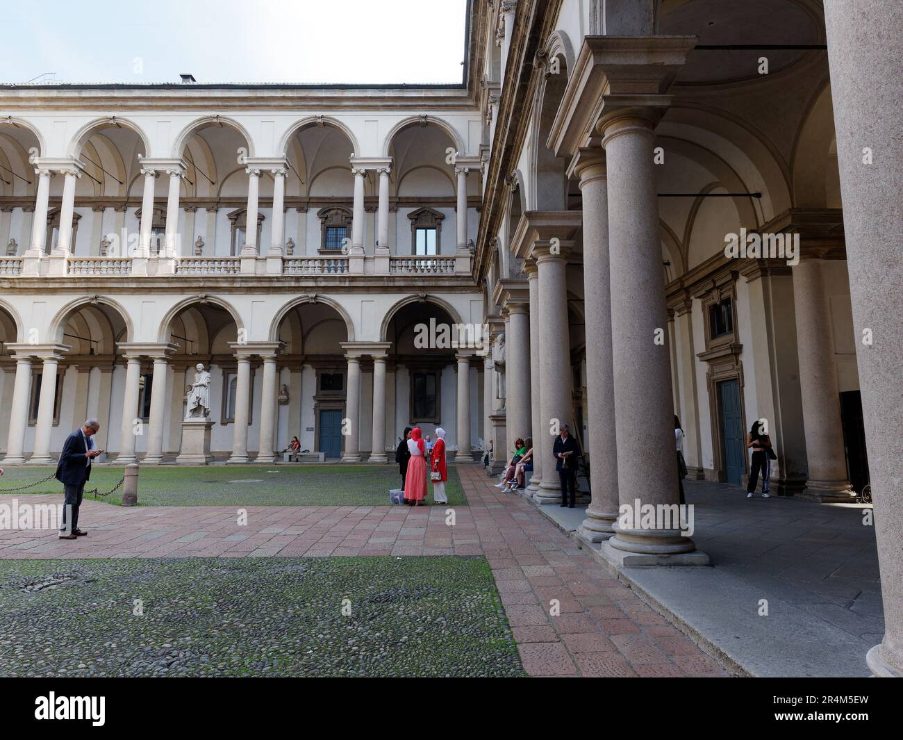 Tourists in Palazzo di Brera (Brera Palace) courtyard, city of Milan, Lombardy, Italy. The Palace houses the famous Pinacoteca (Art Gallery) Stock Photo