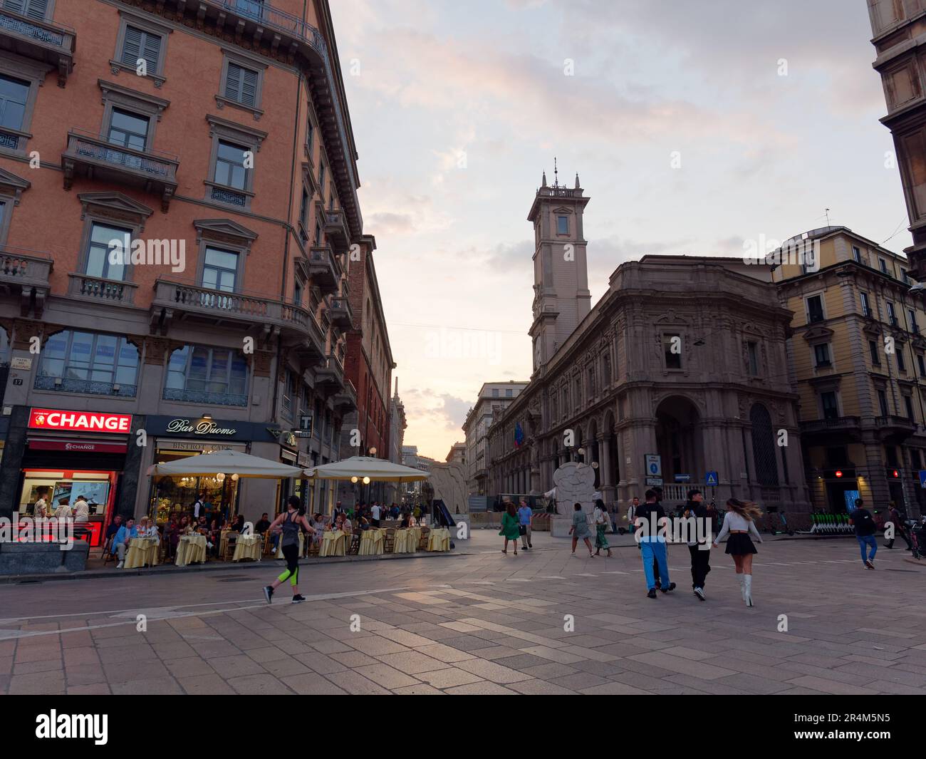 People pass by Bar Duomo opposite Palazzo dei Giureconsulti in the City of Milan, Lombardy, Italy Stock Photo