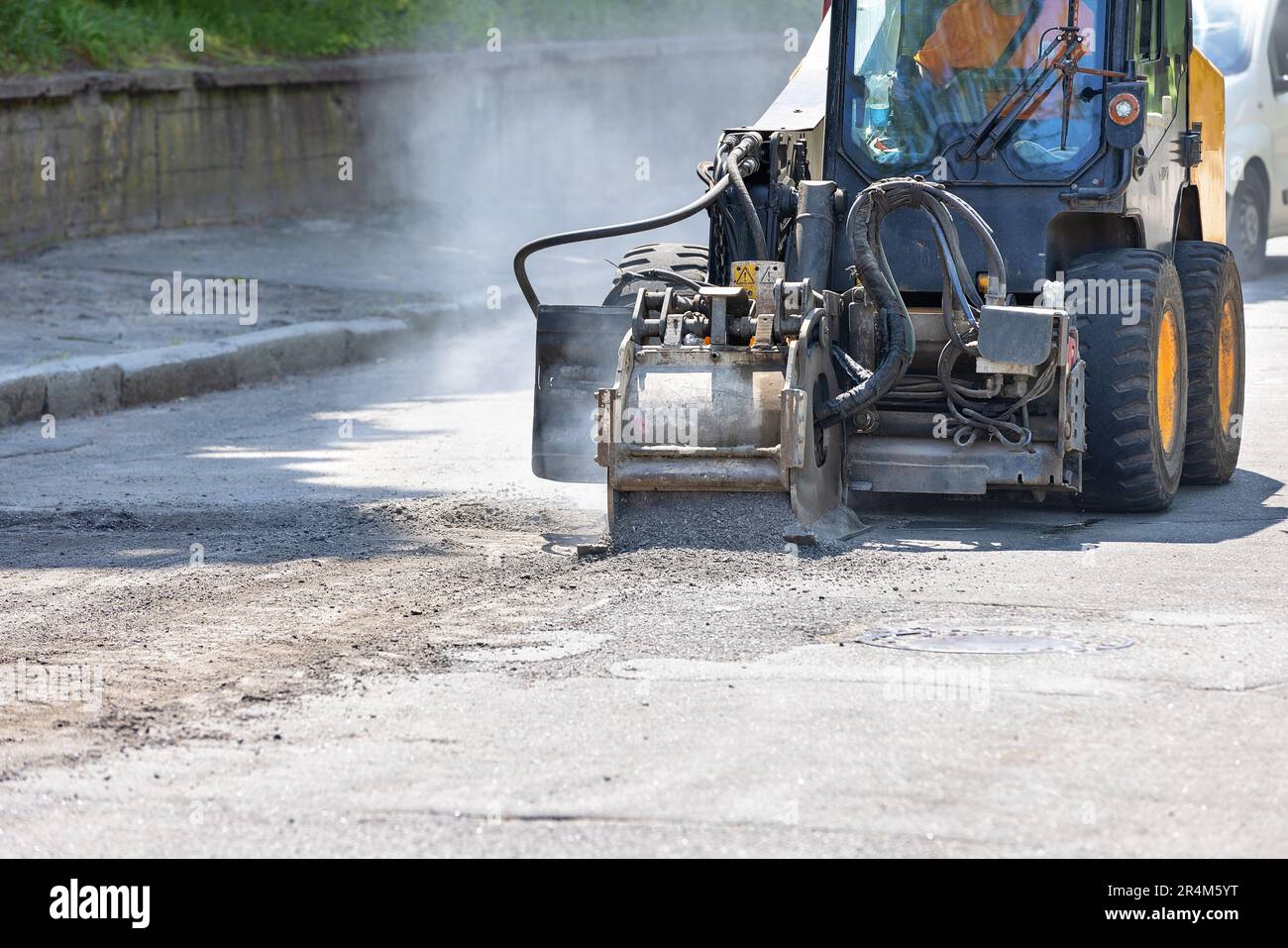 A construction road tractor with a powerful attachment of a milling