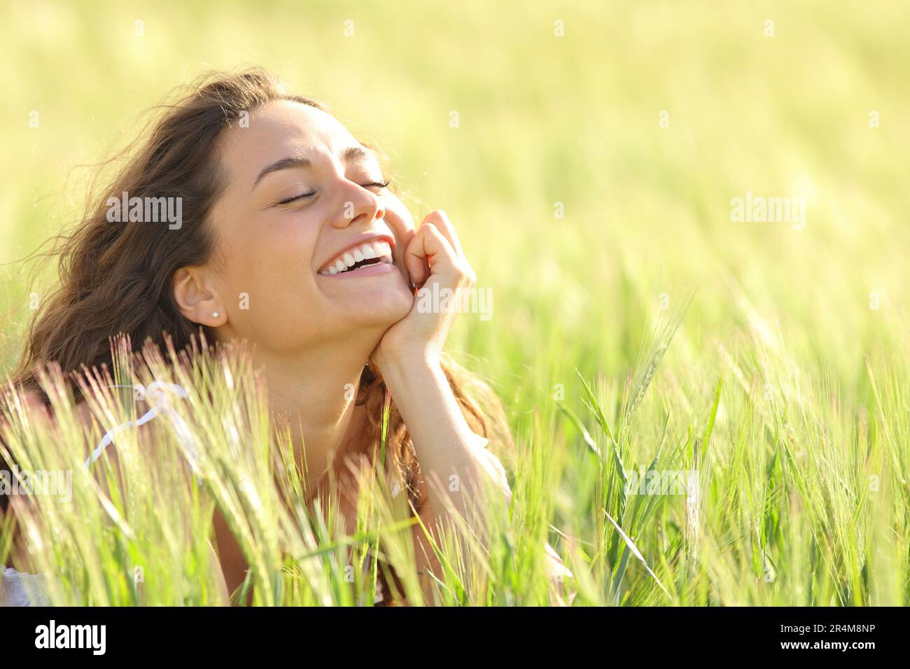 Funny woman enjoying of nature laughing in a field Stock Photo