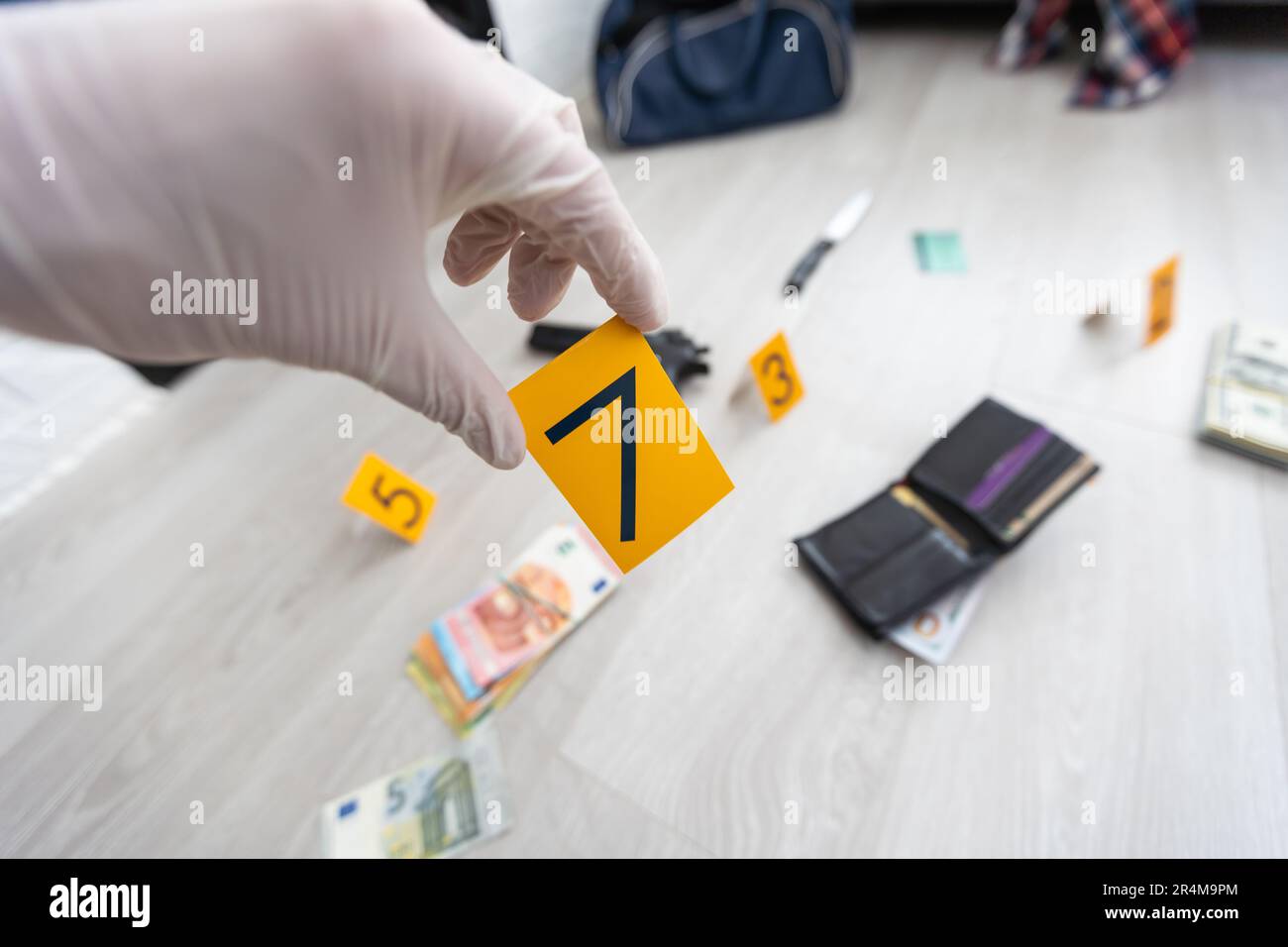Detective in gloves looking evidence, crime scene Stock Photo Alamy