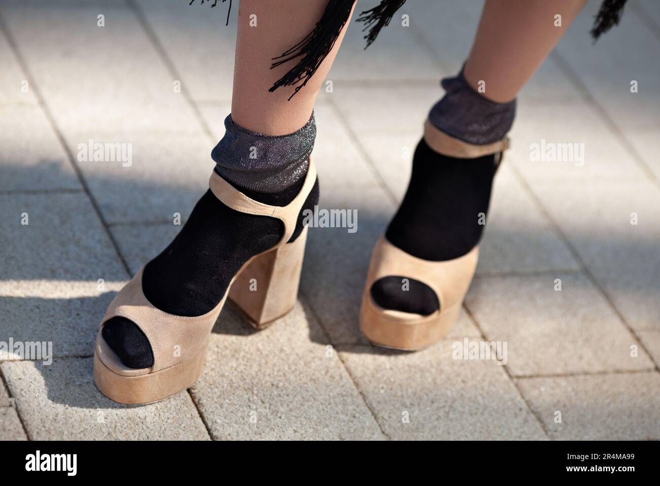 Close up Female legs in socks and open toed sandals on high heels. Stylish clothes and shoes. Trend fashion style. Stock Photo