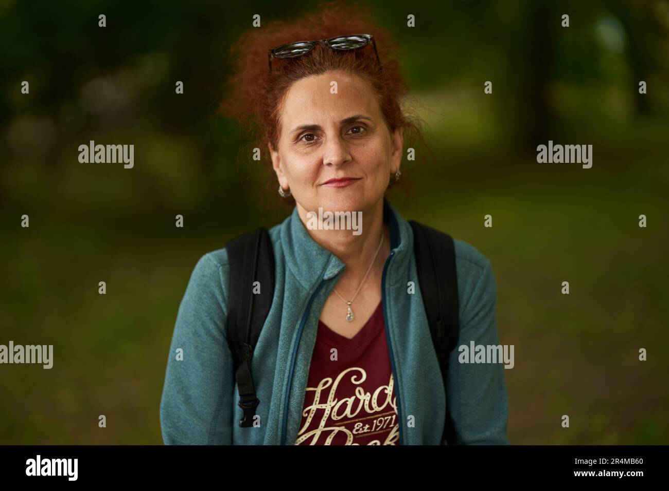 Portrait of a curly hair redhead woman outdoor in the park Stock Photo ...