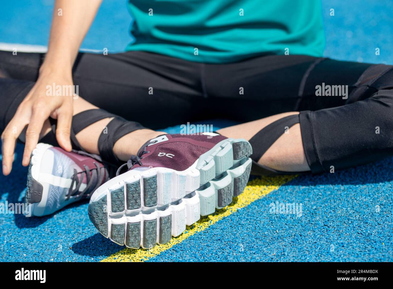 Young female athlete wears running shoes from the Swiss shoe brand ON ...