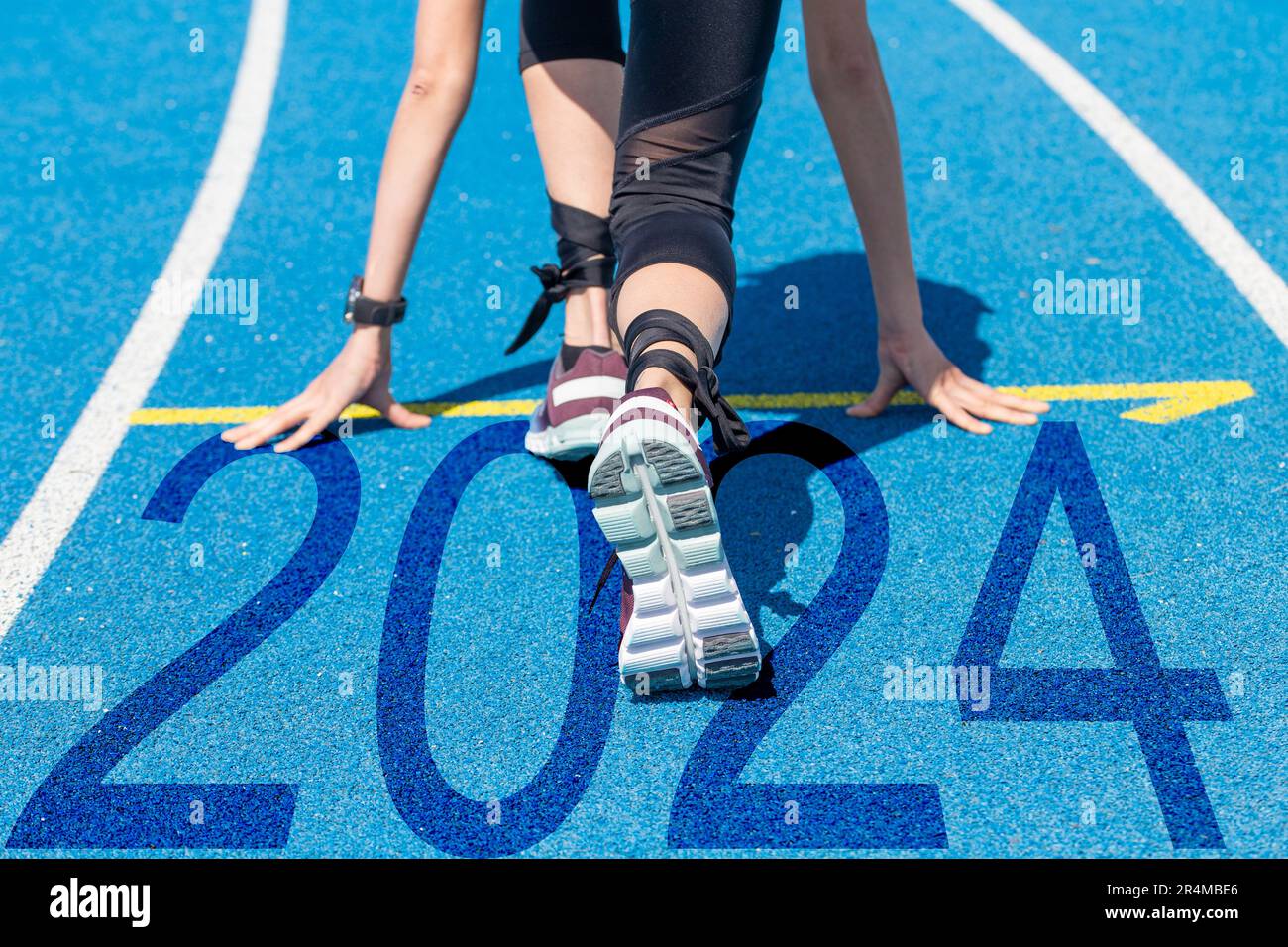 New Year's Eve greetings 2024 Track and field athlete at the start, on