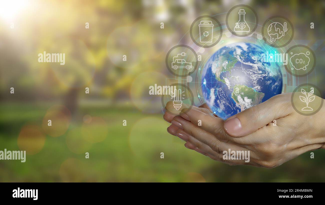 Woman's hands with earth on green blured nature background with eco ...