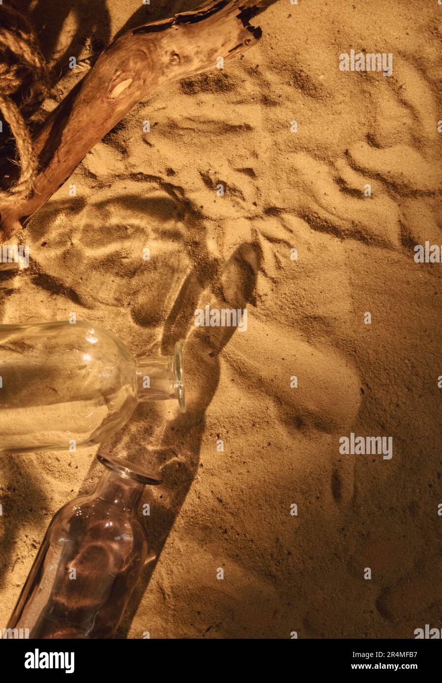 Sand background nautical composition bottles rope Stock Photo - Alamy
