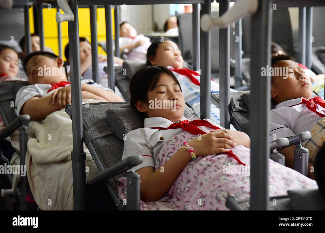 HANDAN, CHINA - MAY 29, 2023 - Primary school students use 'reclining desks and chairs' for lunch break in Handan, Hebei province, China, May 29, 2023 Stock Photo
