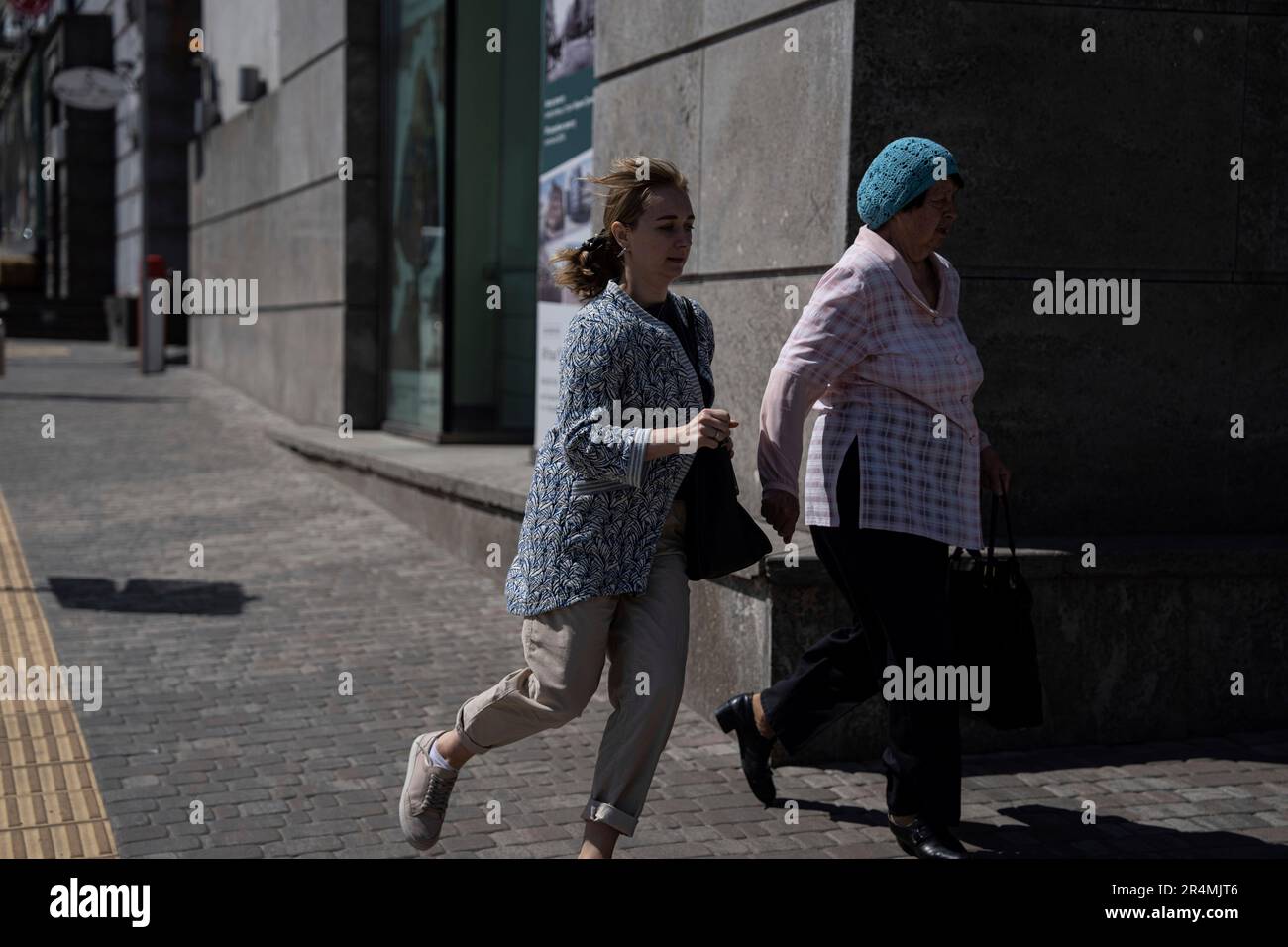 People rush to take shelter during a Russian rocket attack in Kyiv ...