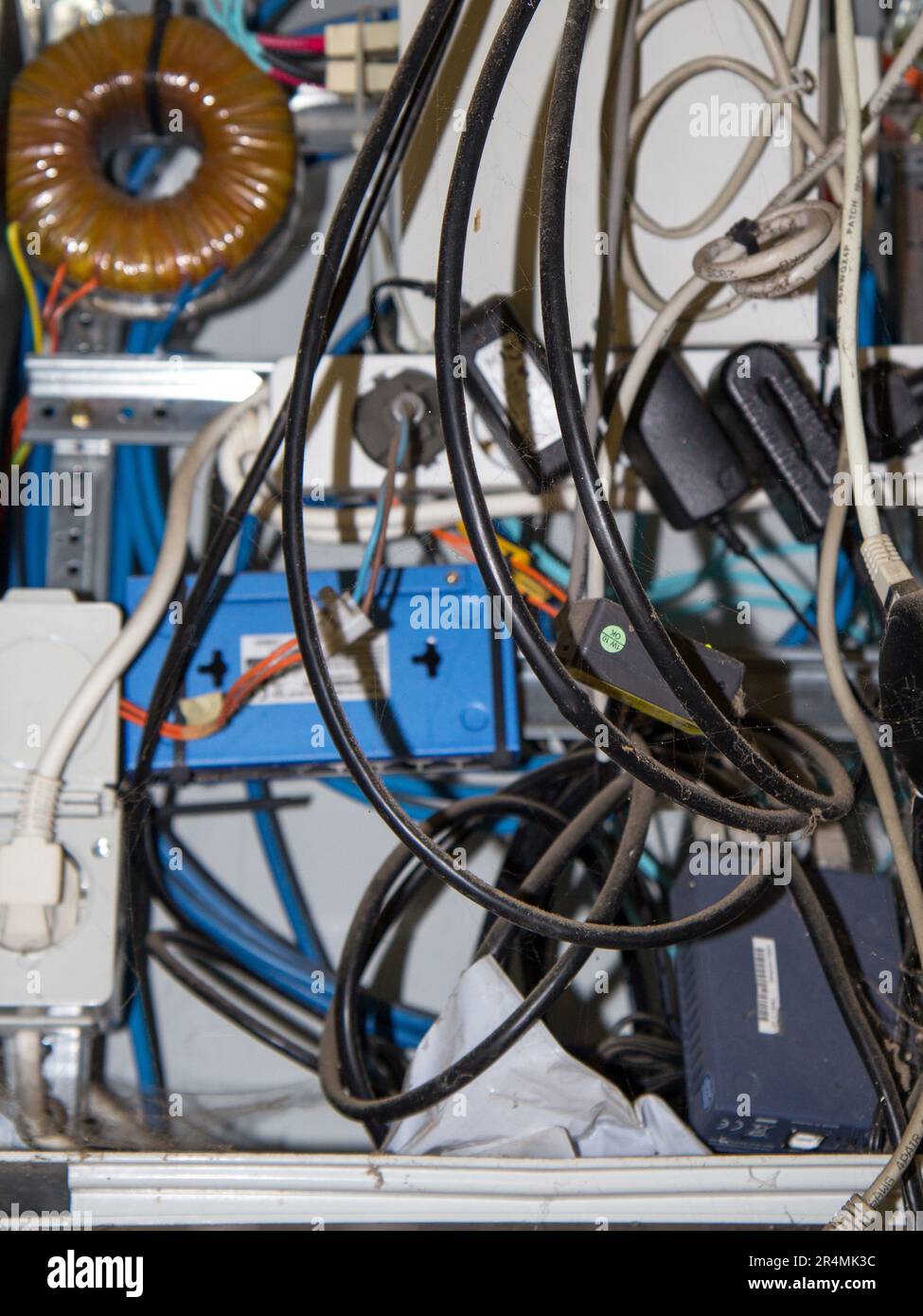 Closeup on wires and camera cables inside an dirty electrical