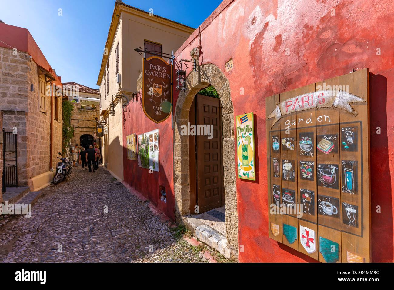 View of colourful bar in narrow cobbled street, Old Rhodes Town, UNESCO World Heritage Site, Rhodes, Dodecanese, Greek Islands, Greece, Europe Stock Photo