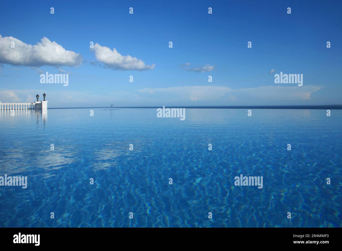 Enormous infinity pool beneath a blue sky at a hotel resort in the Philippines. Stock Photo