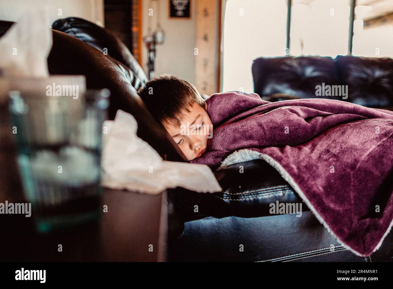 Young boy napping not feeling well Stock Photo