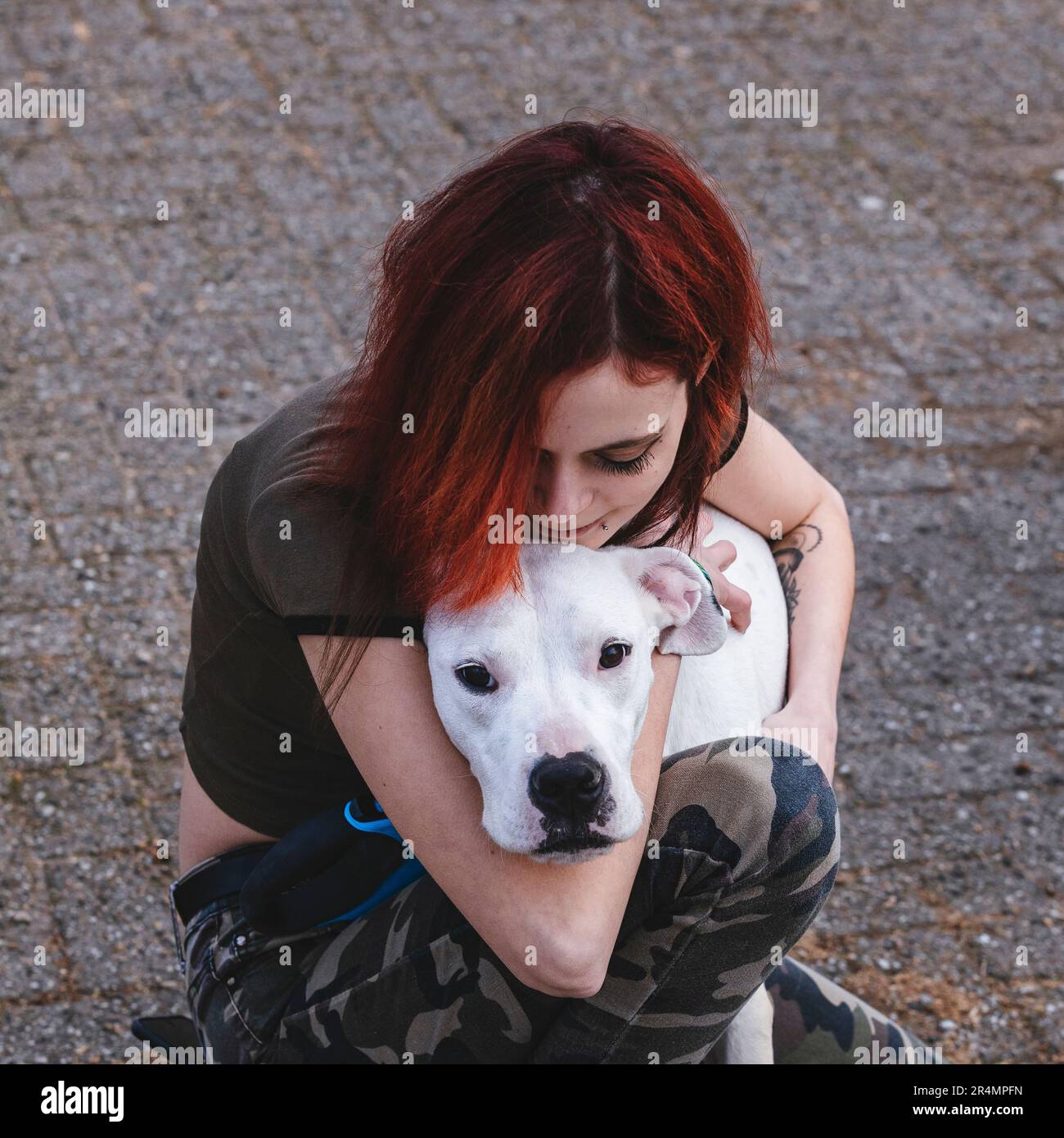 The woman is hugging her dog - dogo argentino Stock Photo