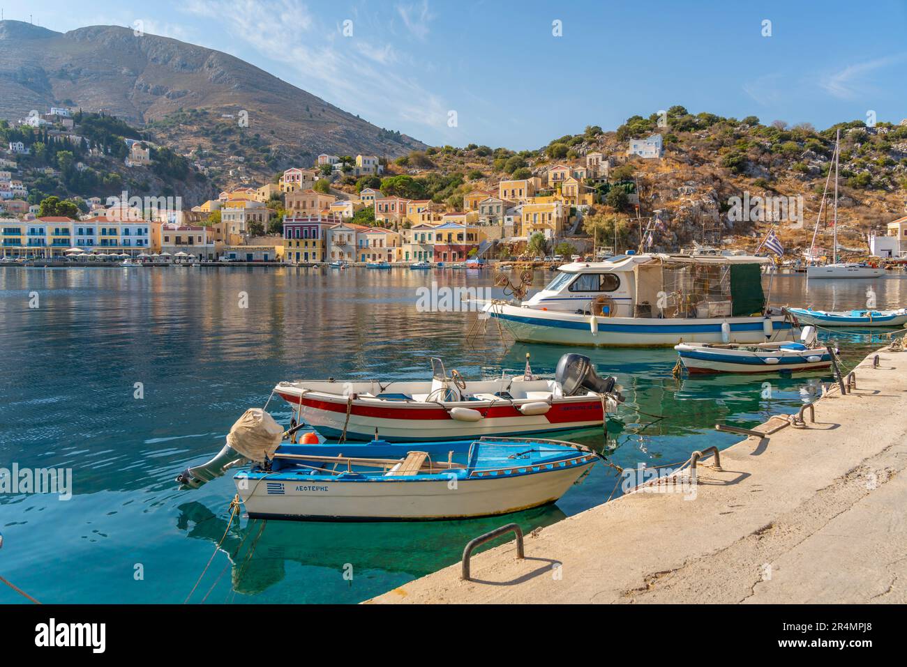 View of boats in harbour of Symi Town, Symi Island, Dodecanese, Greek Islands, Greece, Europe Stock Photo