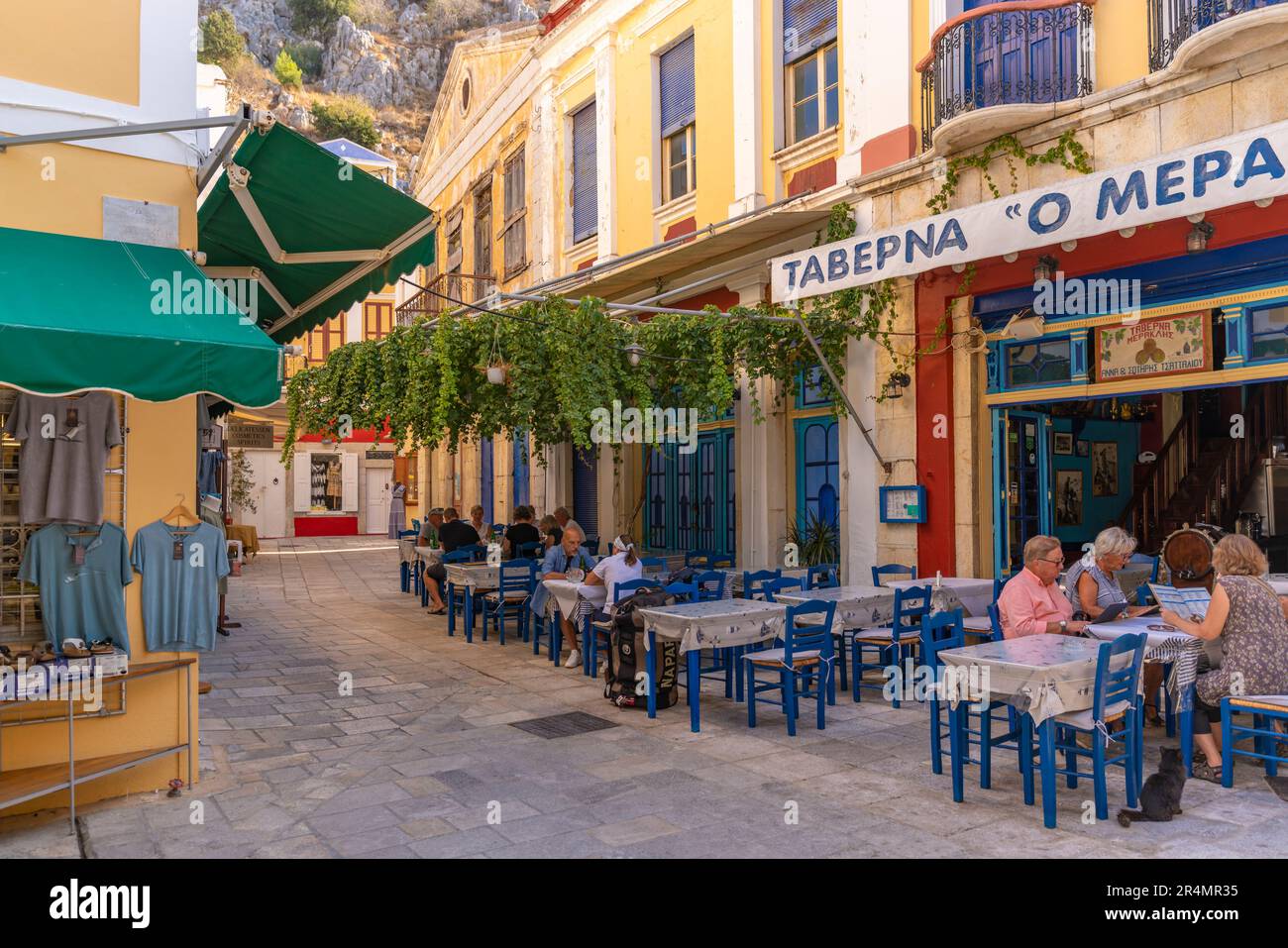 View of restaurant and alfresco eating in Symi Town, Symi Island, Dodecanese, Greek Islands, Greece, Europe Stock Photo