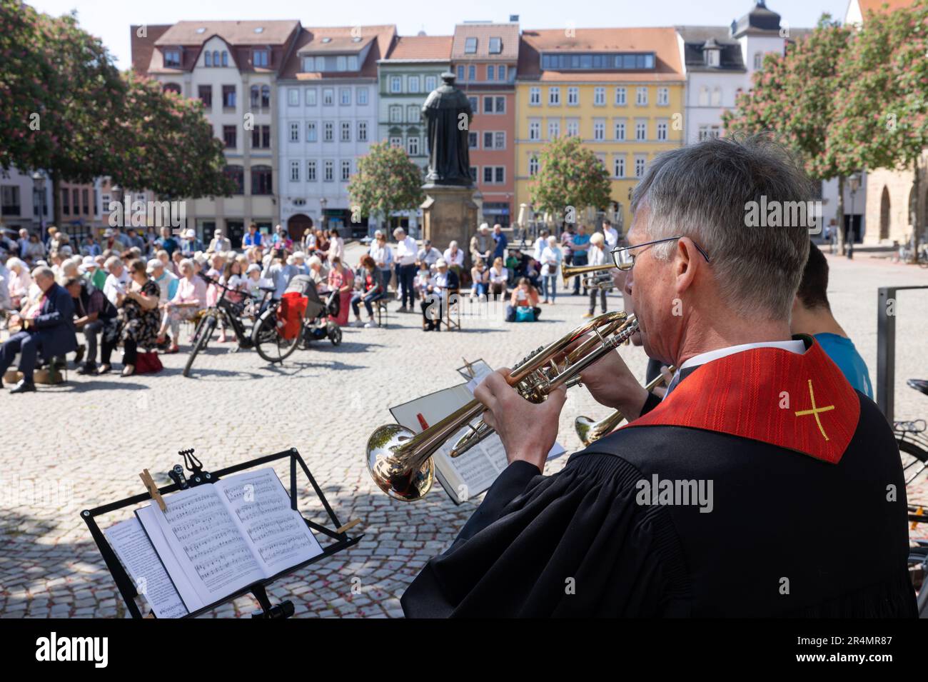 Jena, Germany. 29th May, 2023. Pastor Sebastian Neuß, superintendent in the Jena church district, blows an instrument at an ecumenical open-air service on Pentecost Monday in the market square. Throughout Thuringia, numerous events take place over Whitsun. Credit: Michael Reichel/dpa/Alamy Live News Stock Photo