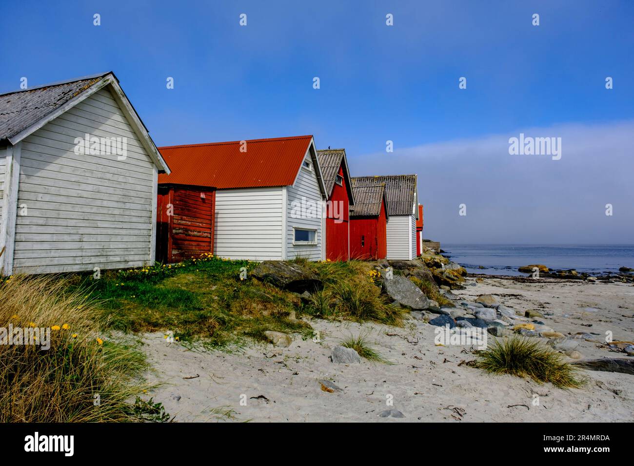 Olberg; Olbergstranden; Raege; Norway; May 20 2023, Row Or Line Of Traditional Colourful Beach Huts Against A Clear Early Morning BLue Sky With No Peo Stock Photo