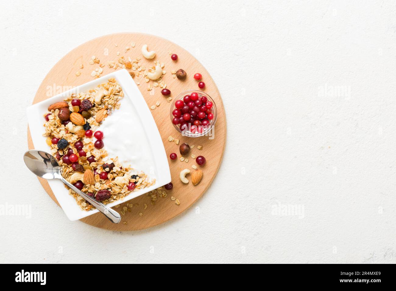 Healthy breakfast food with granola, yogurt, fruits and nuts. Dessert