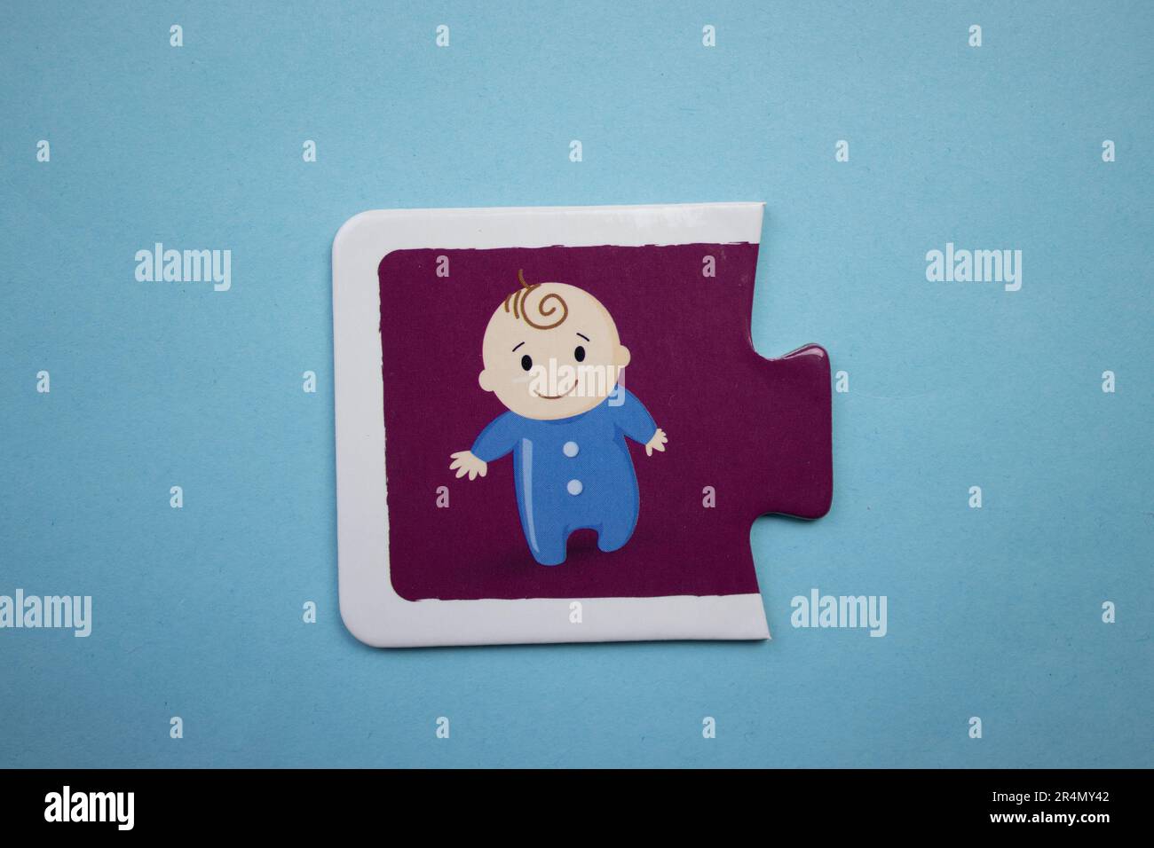 Picture puzzles placed on a blue background. Happy baby Stock Photo - Alamy