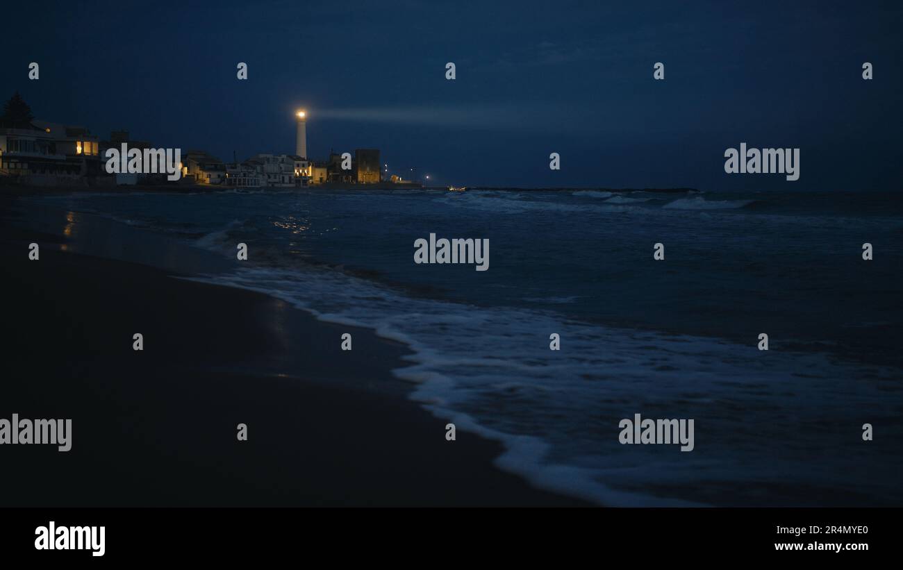Beam of light cast by the lighthouse at night Stock Photo - Alamy