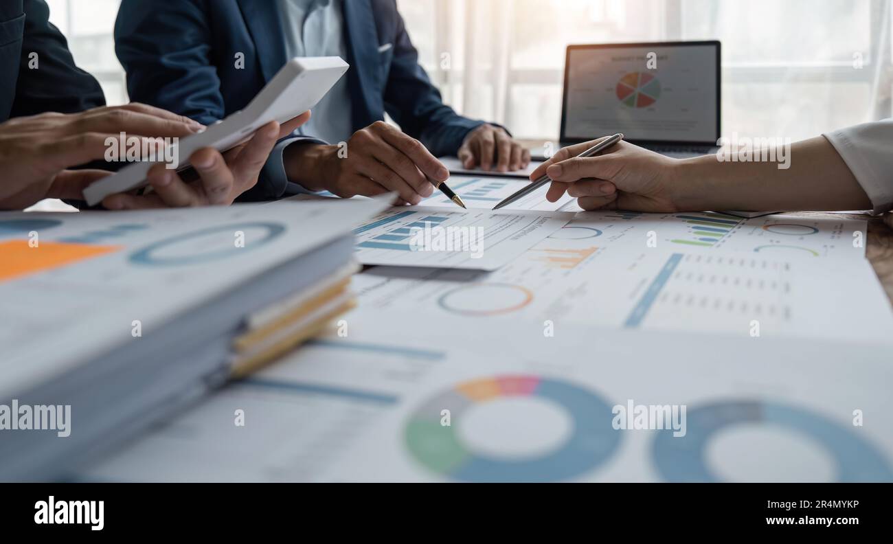 Business team analyzing income charts and graphs with modern laptop ...
