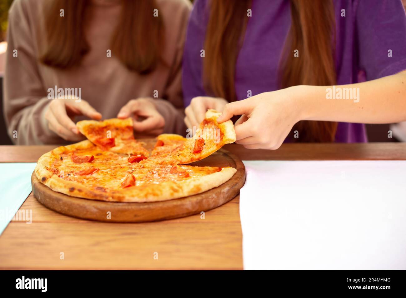 Eating Pizza. Group Of Friends Sharing Pizza Together. People Hands Taking  Slices Of Pepperoni Pizza. Fast Food, Friendship, Leisure, Lifestyle. Stock  Photo