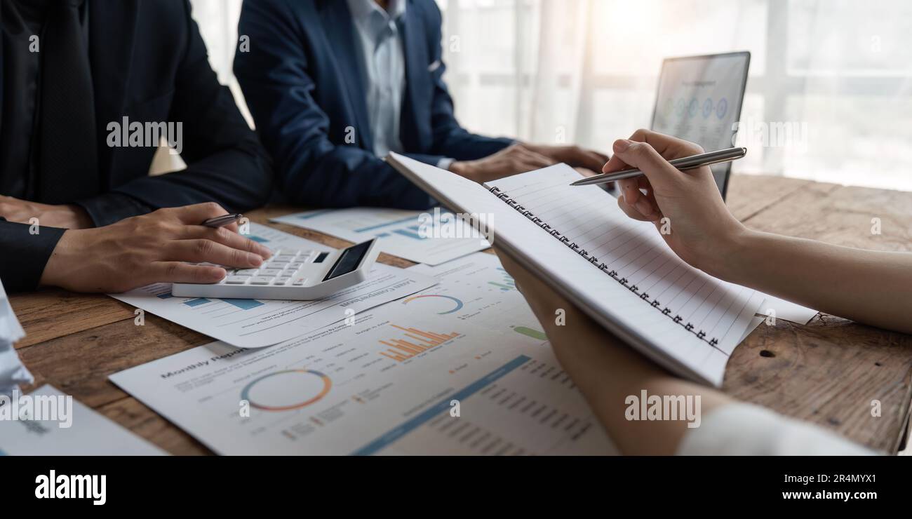 Business team analyzing income charts and graphs with modern laptop ...
