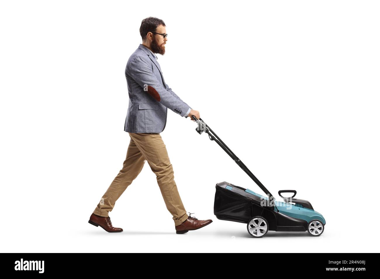Full length profile shot of a bearded man using a lawnmower isolated on white background Stock Photo