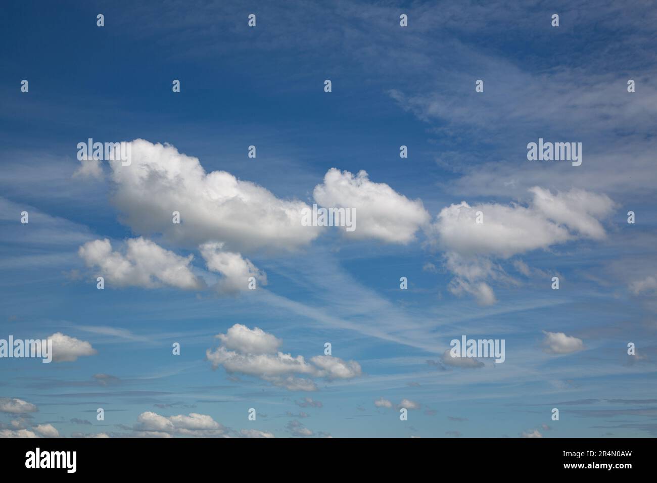 Clouds formed by chemtrails left by airplanes Stock Photo