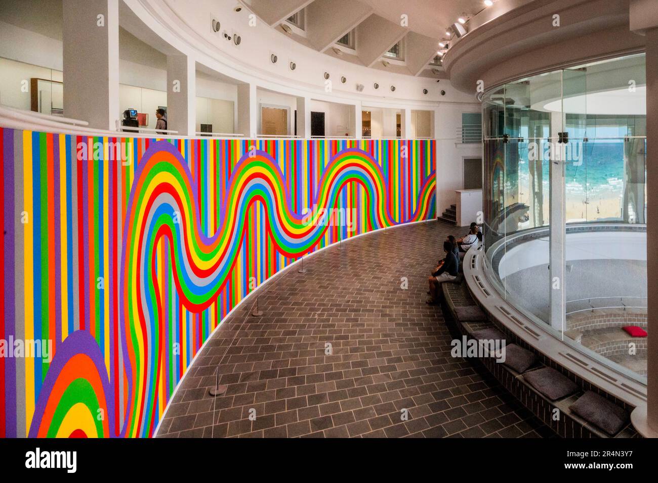The beach reflected in the curved window - Sol LeWitt Wall Drawing #1136 Curved and straight color bands 2004  at Tate St Ives. Stock Photo