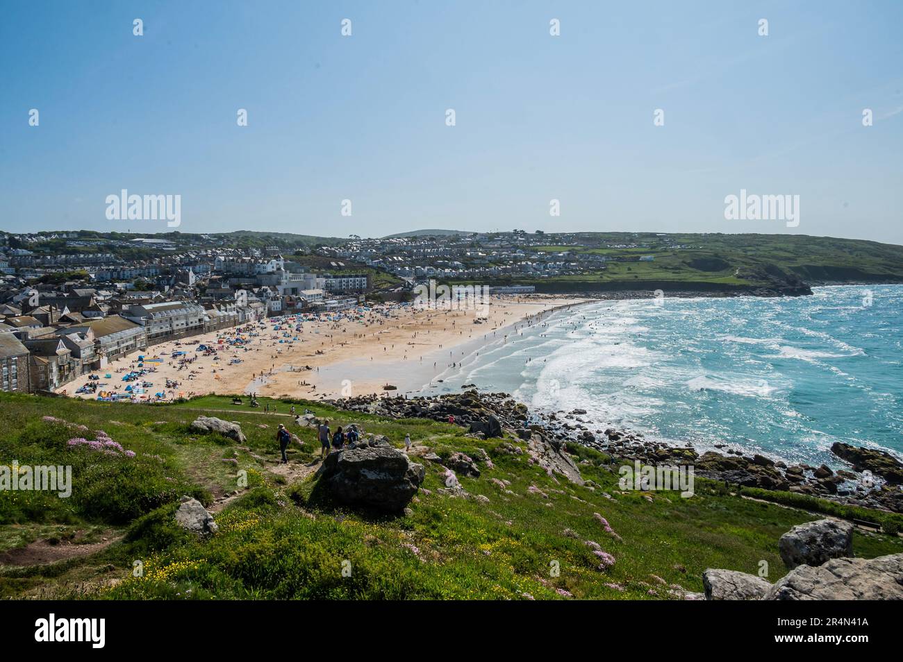 People flock to the baech and the surf - Sunny weather for the bank holiday weekend in St Ives. Stock Photo