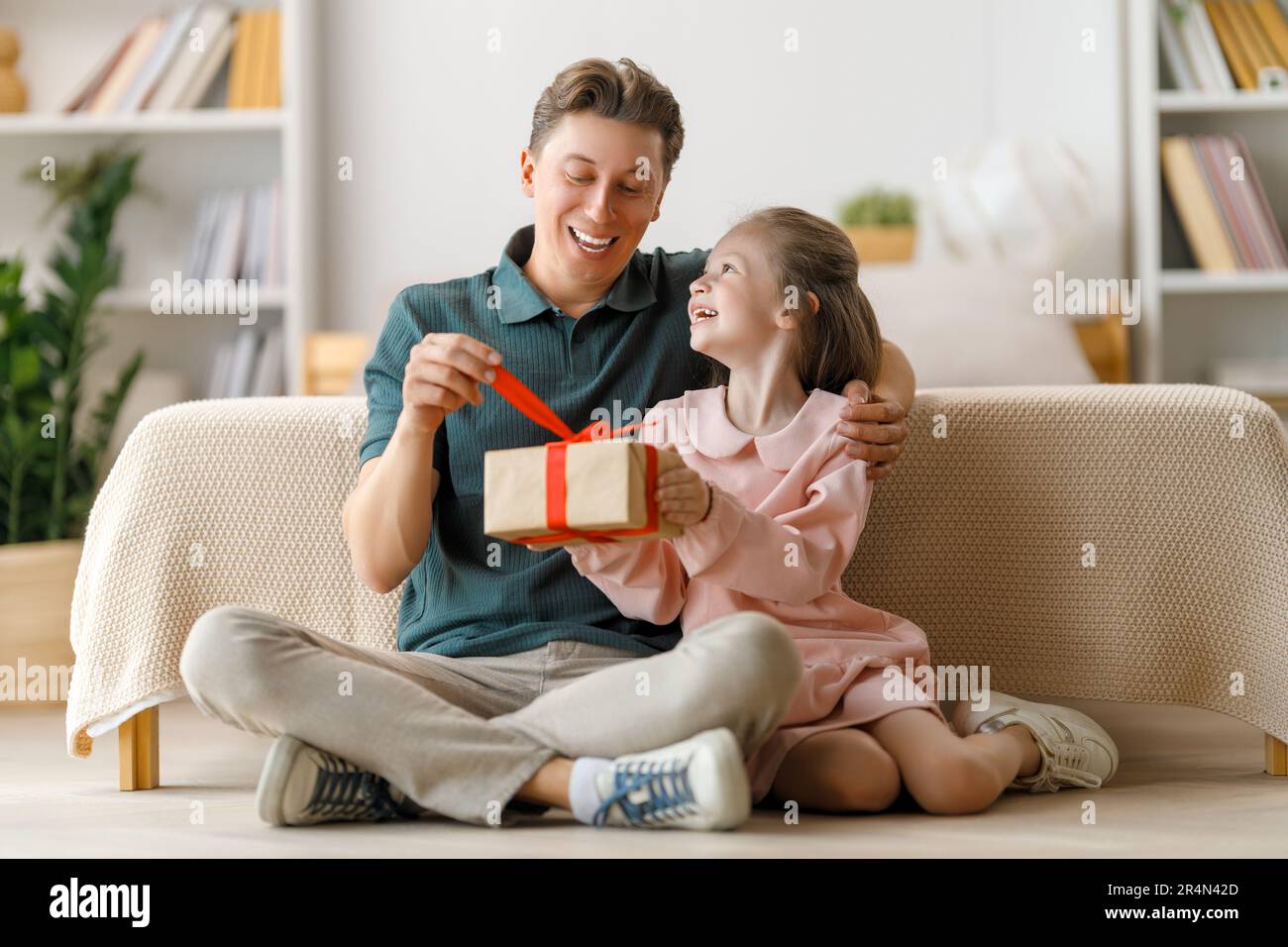 Happy father's day! Child daughter congratulating dad and giving him ...