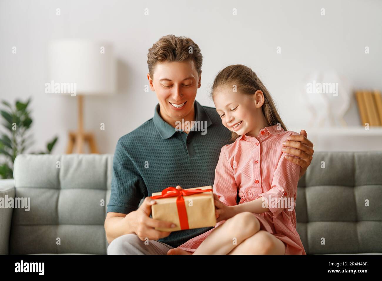 Happy father's day! Child daughter congratulating dad and giving him ...