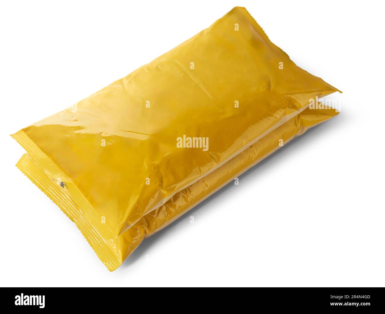 pile of empty or blank yellow plastic bag product, mock-up template packaging for bulk products or food, milk powder, taken from above for graphic des Stock Photo