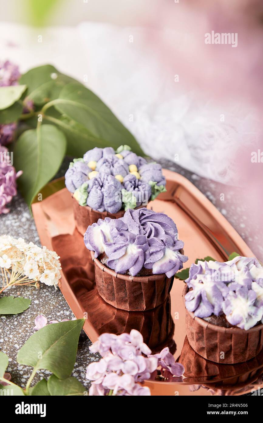 Purple aesthetics trendy floral cupcakes with flowers background ...