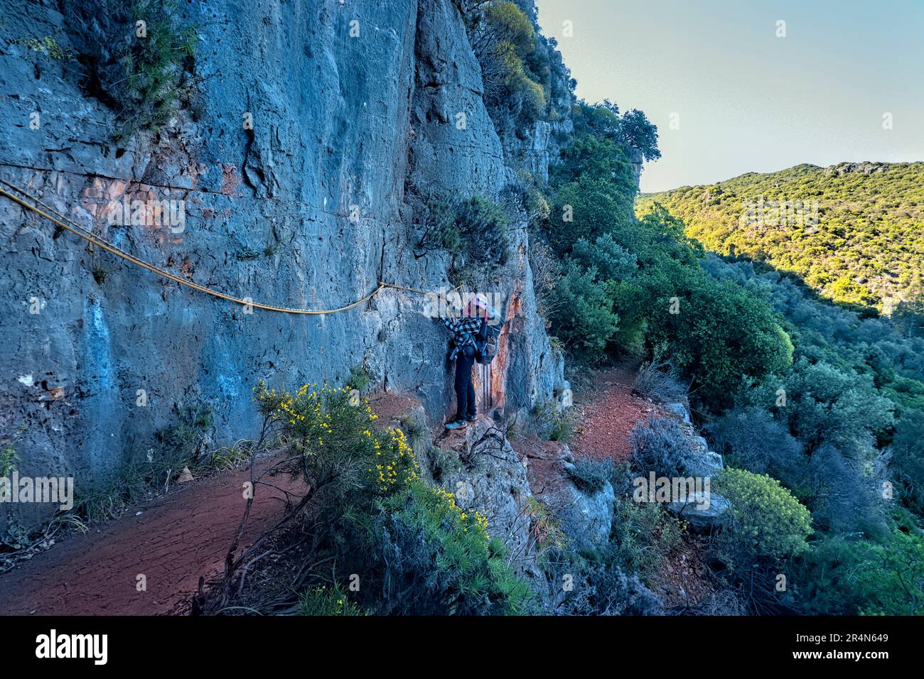 Climbing past Lycian tombs on the Lycian Way, Kaş, Turkey Stock Photo