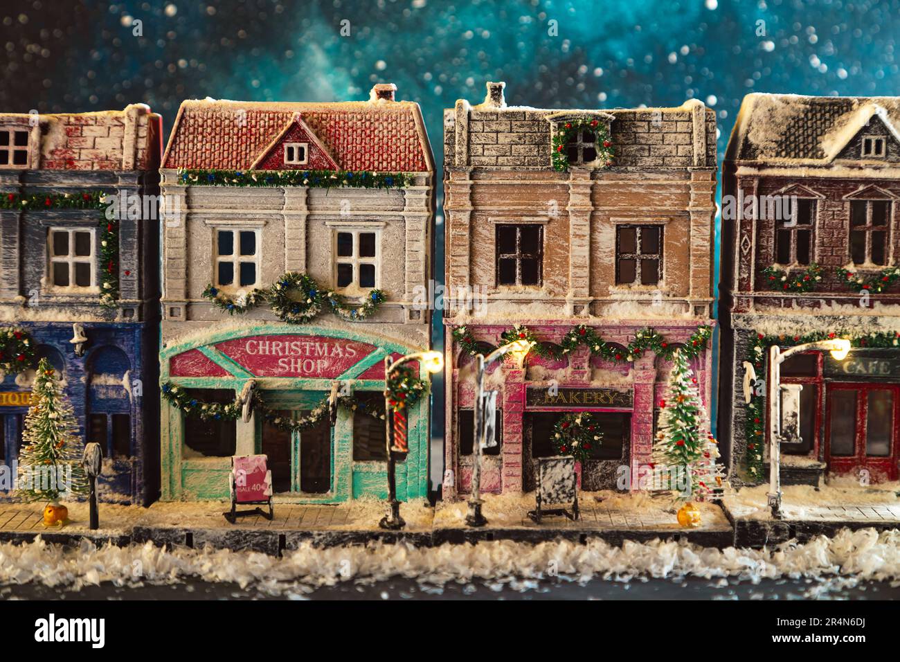 Night snow-covered European street decorated for Christmas. Homemade decorated toy houses. All elements of the image are made and drawn by hand. Stock Photo