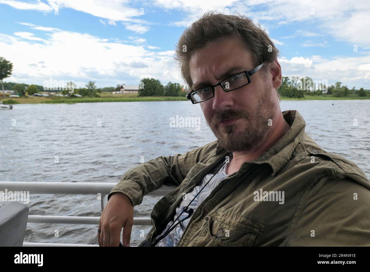 Man sitting railing lake hi-res stock photography and images - Alamy