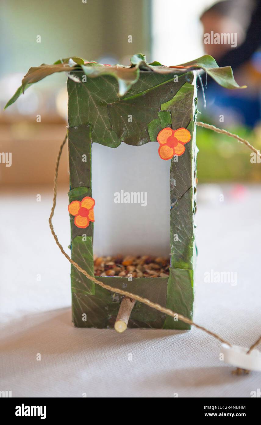 Bird feeder made with recycled materials. Crafts made by children in a nature workshop Stock Photo