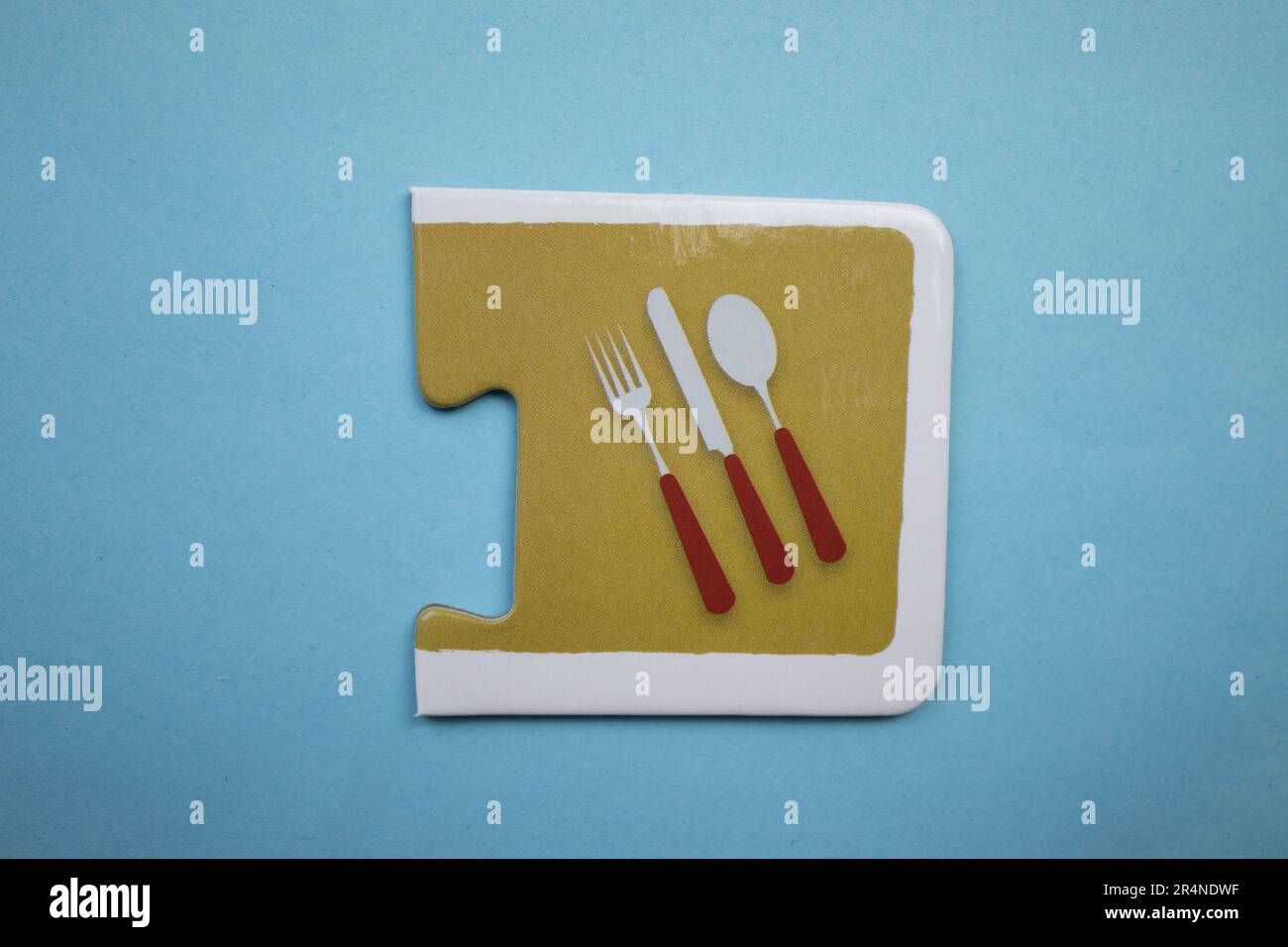 Picture puzzles placed on a blue background. Kitchen set. Stock Photo