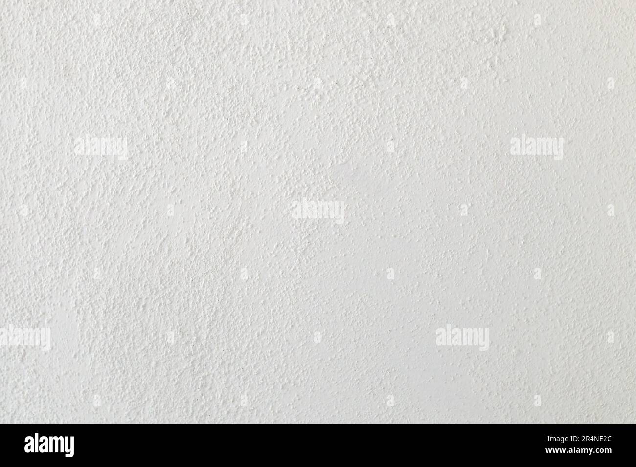 Rough white drywall surface texture as background, so called popcorn