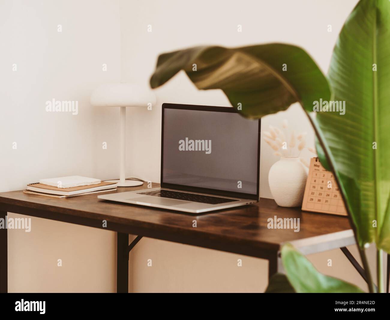 Laptop with blank screen on wooden table in home interior. Workplace ...