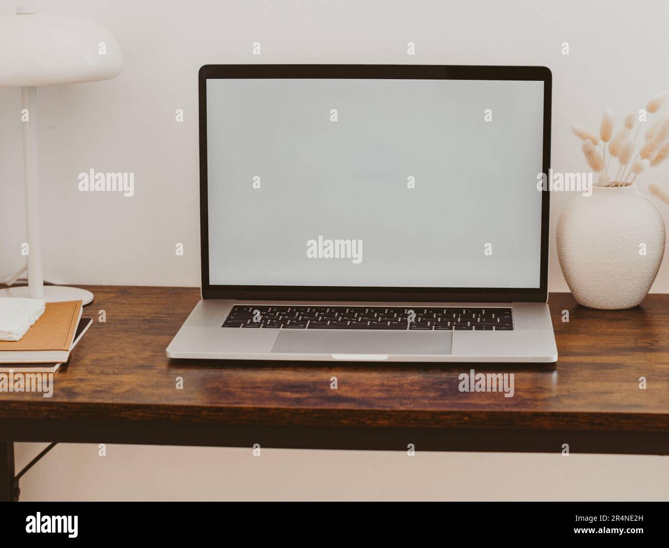 Laptop with blank screen on wooden table in home interior. Workplace ...