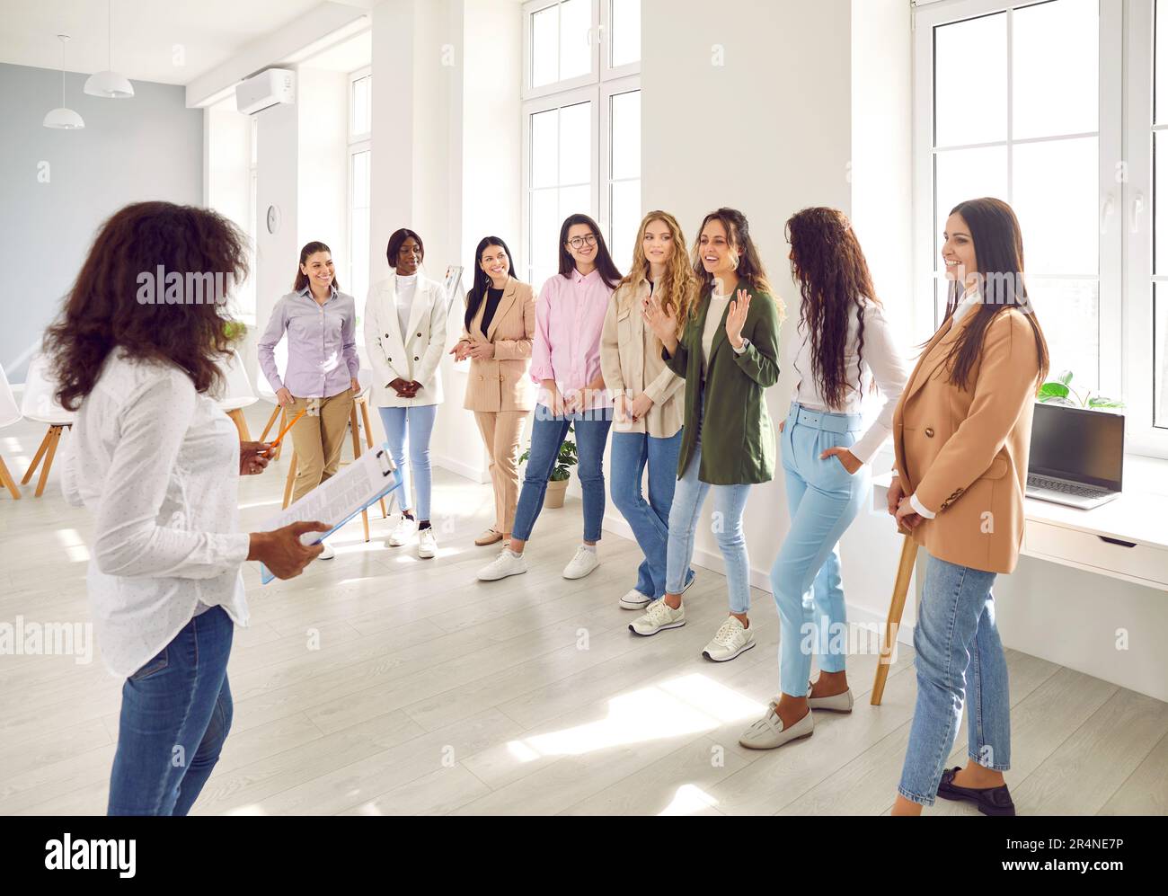 Speaker giving interactive motivational speech at business workshop Stock Photo